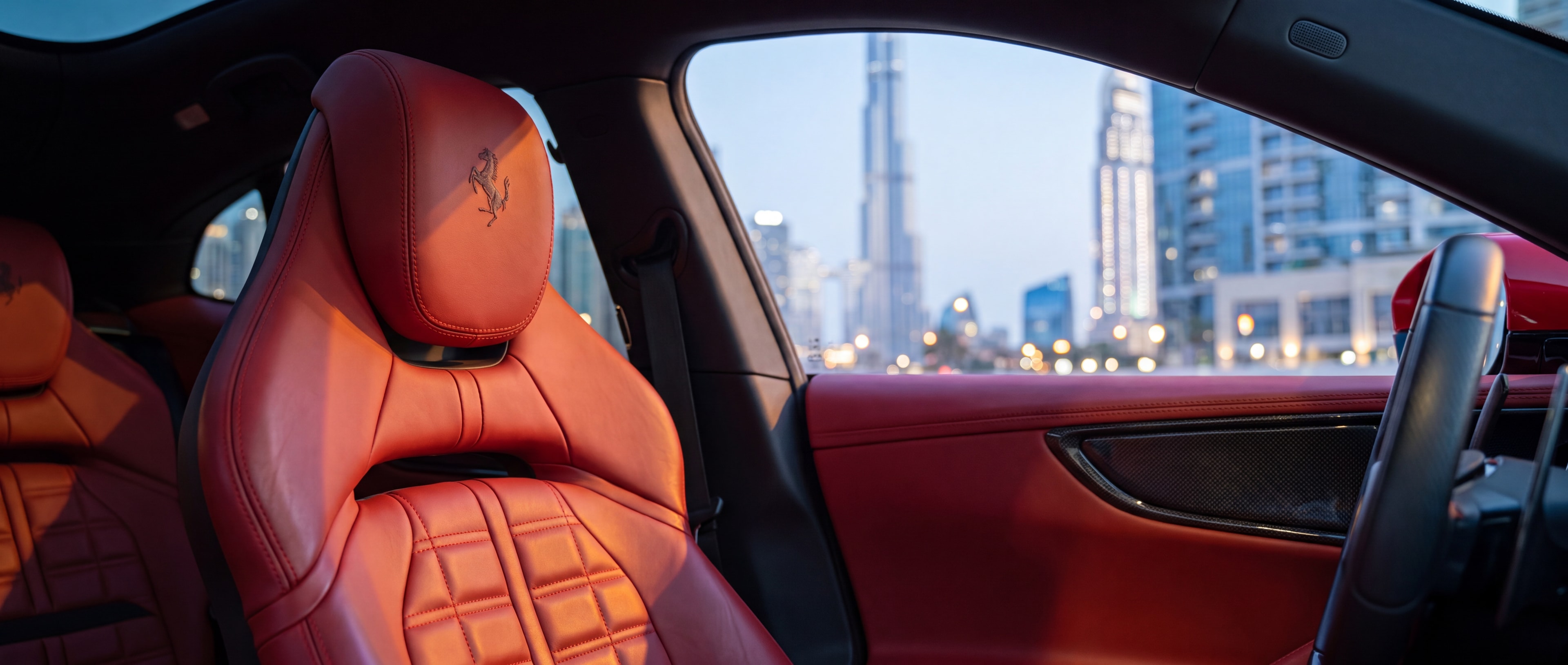 Ferrari Purosangue red leather seat and headrest detail, Downtown Dubai skyline through the window